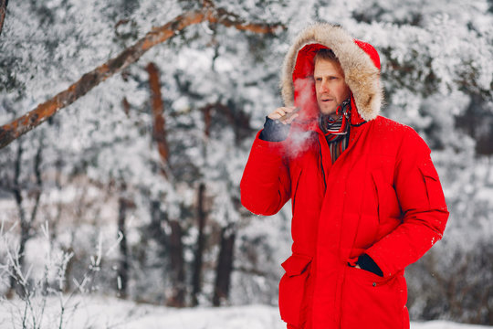 Handsome man with cigar. Male in a red jacket