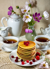 cup of tea and flowers on wooden table