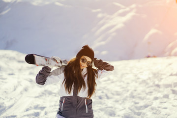 young and active brunette skiing in the snowy mountains