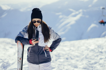 Fototapeta na wymiar young and active brunette skiing in the snowy mountains