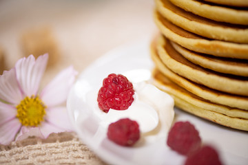 stack of pancakes with maple syrup and fresh berries