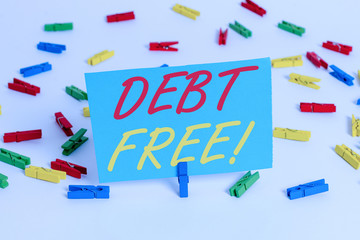 Text sign showing Debt Free. Business photo text does not owning any money or things to any individual or companies Colored clothespin papers empty reminder white floor background office