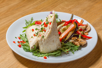 Wrapped tortilla served on plate