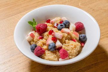 Quinoa with fruits served in white plate