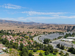 Aerial view of small neighborhood with dry desert mountain on the background in Moorpark