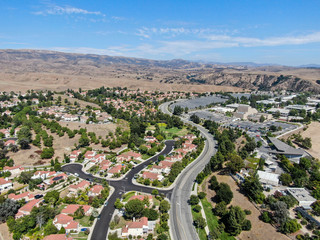 Aerial view of small neighborhood with dry desert mountain on the background in Moorpark