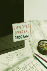 Word writing text Employee Referral Program. Business photo showcasing employees are rewarded for introducing recruits Note paper taped to black computer screen near keyboard and stationary