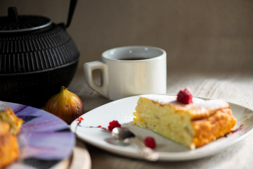 pie, teapot, tea cup and silver spoon