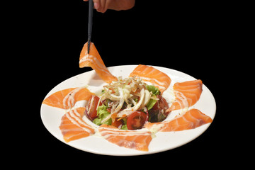Sashimi salmon salad with vegetables Japanese food style on black background