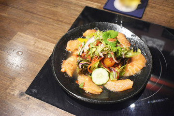 Spicy sashimi salmon salad with vegetables Japanese food style.