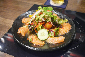 Spicy sashimi salmon salad with vegetables Japanese food style.