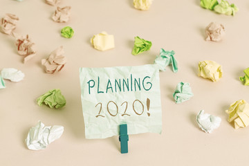 Writing note showing Planning 2020. Business concept for process of making plans for something next...