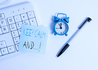 Text sign showing Keep Calm And. Business photo text motivational poster produced by British government White pc keyboard with empty note paper above white background