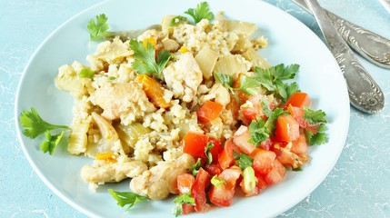 chicken pilaf and cauliflower rice. keto recipe. low carbohydrates, lots of protein. protein nutrition. stewed with celery and carrots.