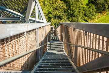 A stair with metal grid steps mounted in a wooden tower in the nature preserve Onlanden province Groningen the Netherlands