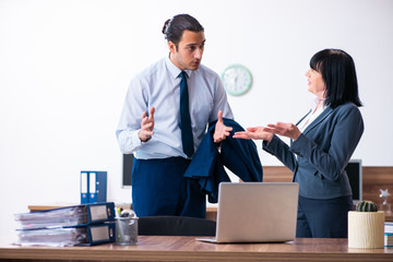 Two employees doing sport exercises in the office