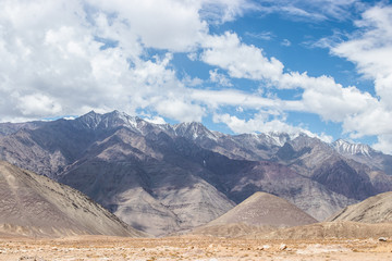 Landscape view of desert sand land with himalaya snow mountain at Leh Ladakh, India