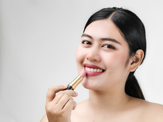 Young Asian woman model with bright makeup with perfect clean skin with pink lips and lipstick.