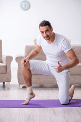 Leg injured man doing exercises at home