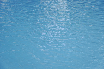 Blue swimming pool edge with refection of water ripple
