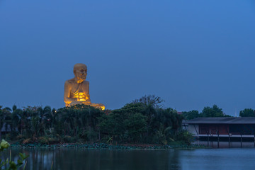 sunrise at the big Buddhist Monks Luang Phor Tuad Statue At Buddha Uttayarn Maharach Project Ayutthaya, Thailand .