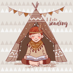 Cute American Indian boy in a tepee tent reading book