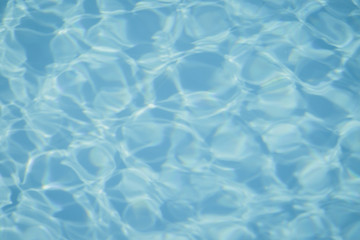 Blue pool water with sun reflections