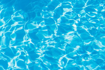 Blue pool water with sun reflections