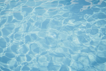 Blue pool water with sun reflections