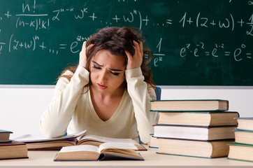 Young female math teacher in front of chalkboard