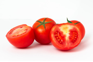 Group of haft tomatoes sliced on white background.