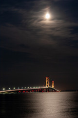 Obraz premium Full Moon over the Mackinac Bridge from St. Ignace, Michigan
