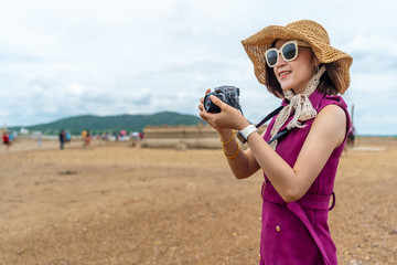 traveller woman taking a photo with camera