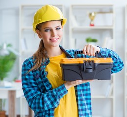 Woman with toolkit in workshop