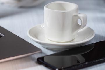 Cup of coffee on table, white cup, office desk, business area, coffee break office