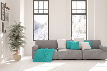 Fototapeta premium Stylish room in white color with sofa and winter landscape in window. Scandinavian interior design. 3D illustration