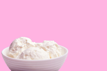 white bowl with white ice cream on a pink background. front view. .place for your text