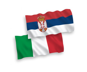 National vector fabric wave flags of Italy and Serbia isolated on white background. 1 to 2 proportion.