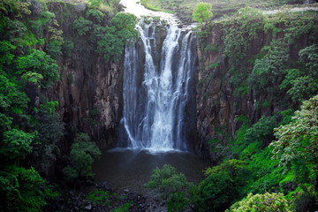 Fototapeta na wymiar Waterfall flowing between the two hills