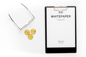 Initial coin offering ICO white paper on white background top view