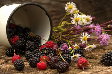 Ripe large blackberry and raspberry with leaves