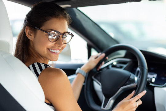 Businesswoman feeling excited in the morning while driving to work
