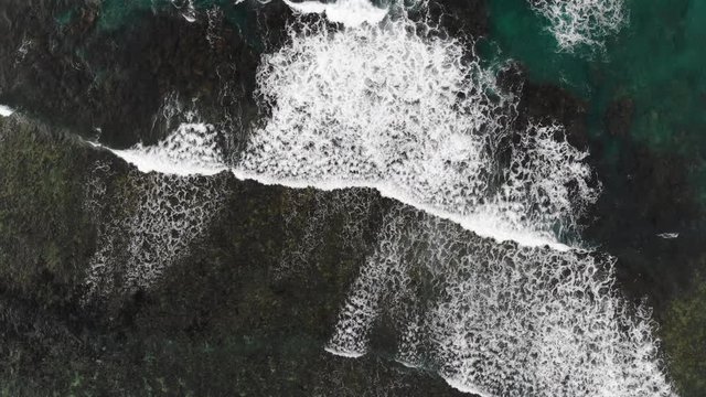 Aerial view of waves crashing over the reef in Samoa in the South Pacific Ocean