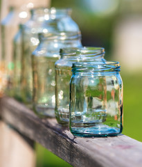 Washed glass jars stand in nature
