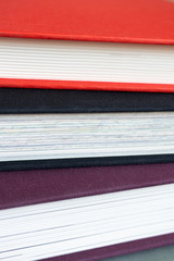 Close-up of several closed books in horizontal position