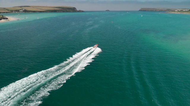 Version Two. Aerial Follow Shot of Speedboat near Daymer Bay in Cornwall, England.