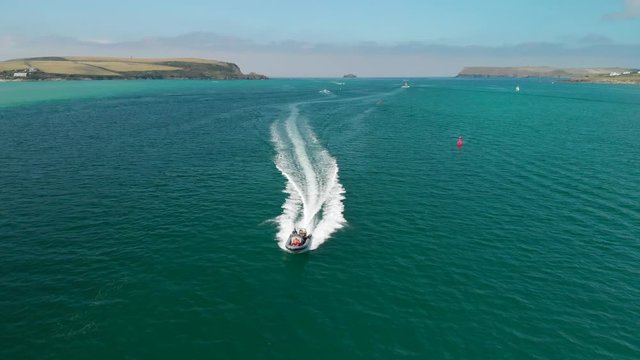 Reverse Tracking Shot of Family on Rib Speed Boat near Polzeath, Cornwall.
