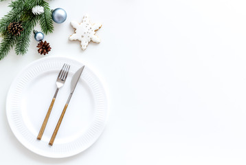 Table setting with spruce, plate, flatware on white background top view mockup