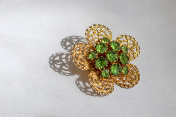 Beautiful antique brooch with bright stones on a white background