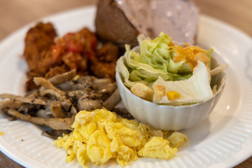 bread, salad, egg with mushroom for breakfast